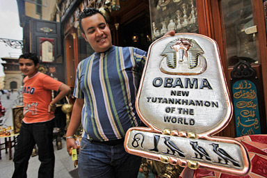 A souvenir shop-owner displays a recently-made metal plaque for sale to tourists reading "Obama, New Tutankhamun of the World", in the Khan el-Khalili market area of Cairo, Egypt Thursday, May 28, 2009, ahead of President Barack Obama's planned June 4 speech in Cairo on U.S. relations with the Muslim world. The sign refers to Tutankhamun who was one of the last Pharaohs of Egypt's 18th Dynasty and ruled during a crucial, turmoil-filled period in Egyptian history. Hieroglyphics at base of plaque were claimed by the vendor to spell the name "Obama".