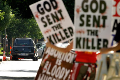 Protesters from Rev. Fred Phelps' Westboro Baptist Church demonstrate during funeral services for Dr. George Tiller at College Hill United Methodist Church in Wichita, Kan., June 6, 2009