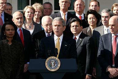 Surrounded by members of his cabinet, U.S. President George W. Bush speaks in the Rose Garden of the White House after a cabinet meeting in Washington November 9, 2006.