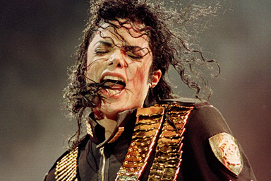 In this Aug. 29, 1993 file photo, pop singer Michael Jackson performs during his "Dangerous" concert in National Stadium, Singapore.