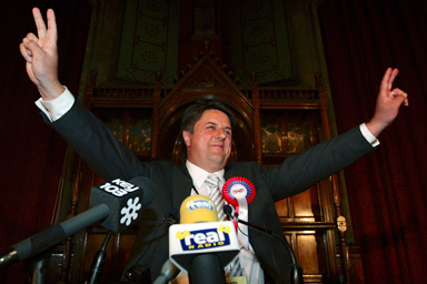 Leader of the British National Party Nick Griffin gestures after he won a seat in the European Parliament at the Town Hall in Manchester, northern England June 8, 2009.