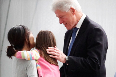 Freed U.S. journalist Euna Lee (L) is embraced by her daughter Hana Saldate and former U.S. President Bill Clinton after arriving with fellow freed U.S. journalist Laura Ling from North Korea in Burbank, California August 5, 2009.