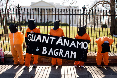 Protesters calling for the closing of the U.S.detention facilities at Guantanamo Bay, Cuba, and at Bagram Air Base, Afghanistan, stand outside of the White House in Washington, March 5, 2009.