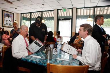 Mack Sheav takes Vice President Joe Biden food order at the M&D Cafe in Denver on Tuesday, May 26, 2009, as he sits with Sen. Michael Bennet, D-Colo.