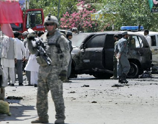 A U.S. soldier stands guard near the site of a suicide attack in Mehterlam, the capital of Laghman province, east of Kabul, Afghanistan on Wednesday, Sept. 2, 2009. A Taliban suicide bomber detonated his explosives as Afghanistan's deputy chief of intelligence visited a mosque east of Kabul on Wednesday, killing the Afghan official and 22 others. (AP Photo/Rahmat Gul) (AP)