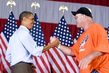 U.S. President Barack Obama (L) shakes hands with union member Charlie Dilbert as he attends an AFL-CIO Labor Day picnic at Coney Island in Cincinnati, September 7, 2009.