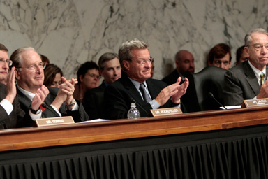 From left to right, Sen. Kent Conrad, D-N.D., Sen. Jay Rockefeller, D-W.V., Chairman of the Senate Finance Committee Sen. Max Baucus, D-Mont., and Sen. Chuck Grassley, R-Iowa, applaud as they near the conclusion of a hearing on heath care reform legislation on Capitol Hill in Washington, in the early morning hours of Friday, Oct. 2, 2009