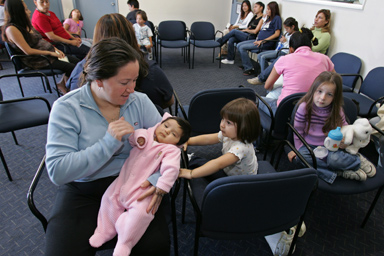Mexican immigrant Alejandro Ruiz of Michoacan, Mexico, holds her two-month-old daughter, Antonia, in a waiting room at a hospital in Salinas, Calif., Thursday, Oct. 13, 2005.