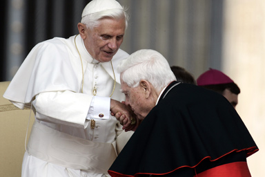 Pope Benedict XVI has his hand kissed by Cardinal Bernard Law during the weekly general audience in St. Peter's Square at the Vatican, Wednesday June 7, 2006.