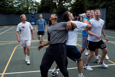 U.S. President Barack Obama, along with Cabinet Secretaries and Members of Congress, watch a shot during a basketball game on the White House court on October 8, 2009