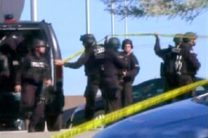 ** DELETES SECOND SENTENCE TO UPDATE ARMY'S ANNOUNCEMENT THAT GUNMAN IS ALIVE ** In this image made from Associated Press Television video, police respond at the scene at the U.S. Army base in Fort Hood Texas where a soldier opened fire, unleashing a stream of gunfire that left at least 12 people dead and at least 31 wounded. (AP Photo/APTN) (AP)