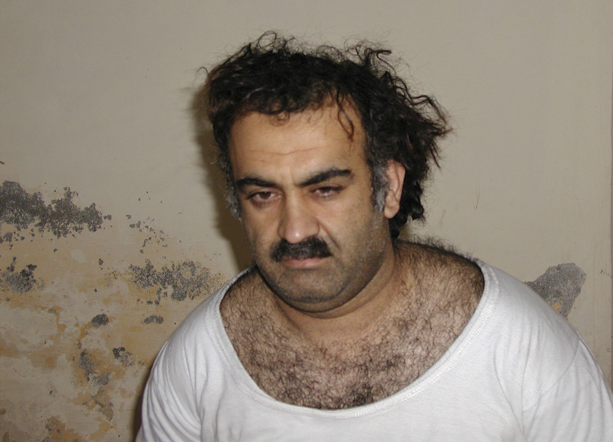 ** FILE ** Khalid Sheikh Mohammed, the alleged Sept. 11 mastermind, is seen shortly after his capture during a raid in Pakistan in this file photo from March 1, 2003 in this photo obtained by the Associated Press. Mohammed, who could face the death penalty for his role in the Sept. 11 attacks, has been peppering his military lawyer with questions in advance of his war crimes trial at Guantanamo, the attorney tells The Associated Press. (AP Photo-File) (Associated Press)