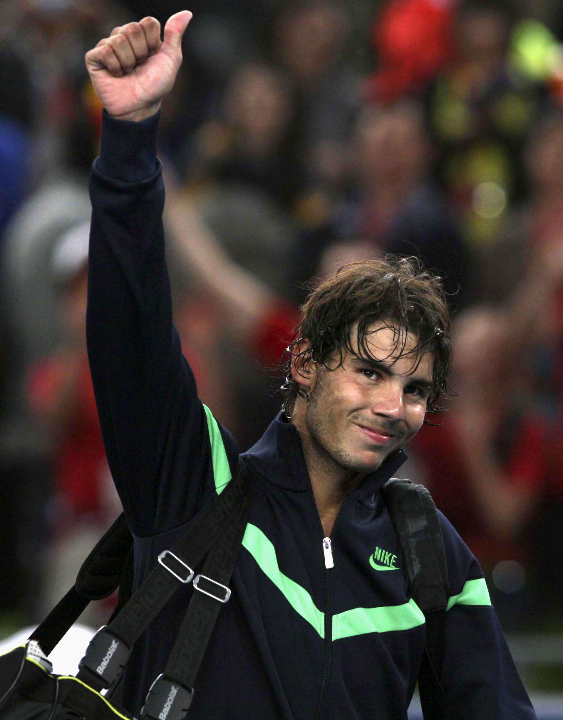 Spain's Rafael Nadal gives Chinese fans a thumbs up after winning over James Blake of the United States in the second round of the China Open tennis tournament in Beijing Thursday, Oct. 8, 2009. Nadal won 7-5, 6-7, 6-3 against Blake. (AP Photo/Elizabeth Dalziel) (Elizabeth Dalziel)