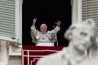 Pope Benedict XVI acknowledges faithful during the Angelus noon prayer celebrated from the window of his studio overlooking St. Peter's Square at the Vatican, Sunday, Oct. 18, 2009.