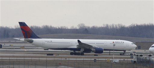The Delta-Northwest Airlines plane N820NW is pulled back to the terminal at the Detroit Metropolitan airport in Romulus, Mich., Saturday, Dec. 26, 2009. A Northwest Airlines passenger from Nigeria, who said he was acting on al-Qaida's instructions, set off an explosive device Friday in a failed terrorist attack on the plane as it was landing in Detroit, federal officials said. (AP Photo/Carlos Osorio) (AP)