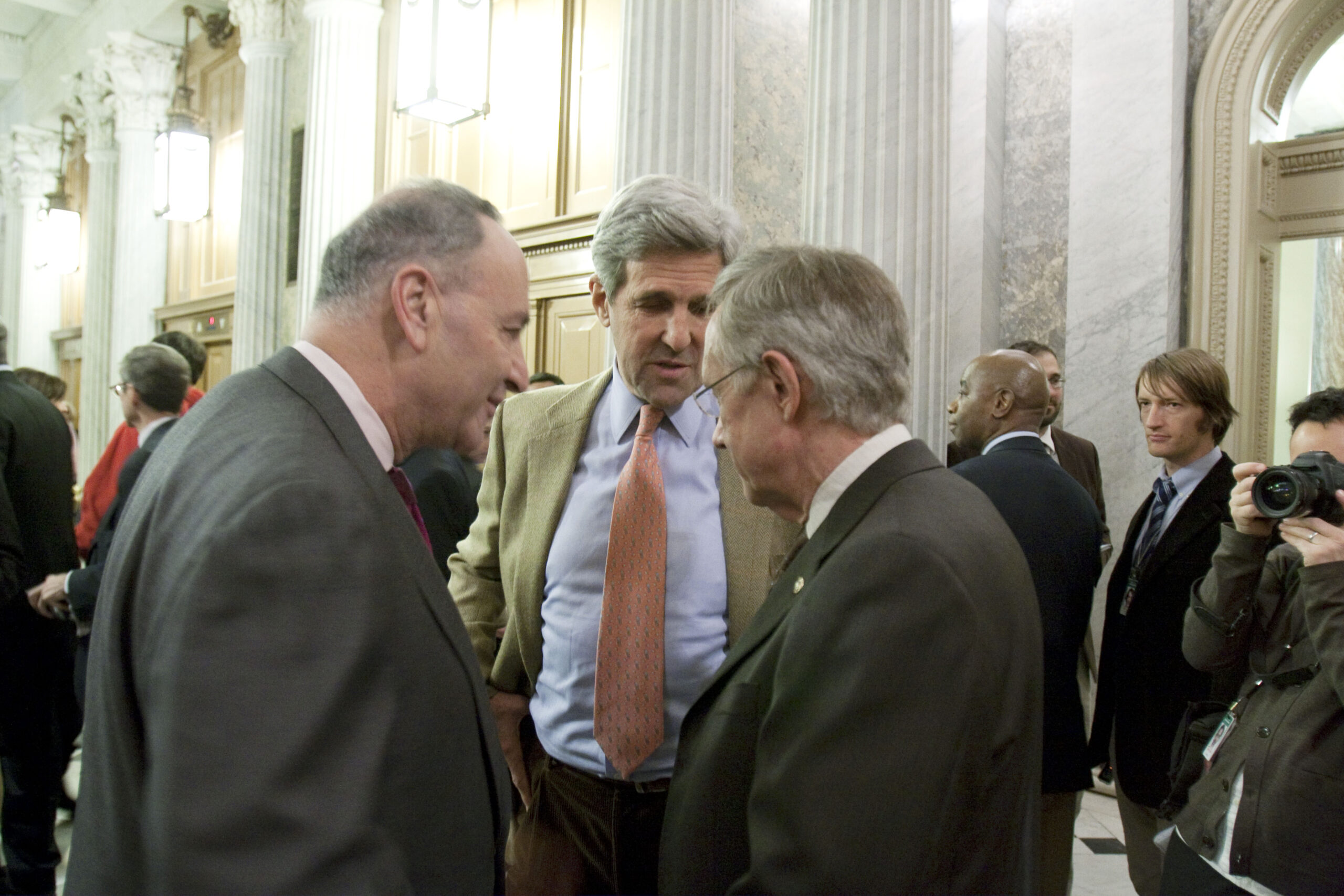 Sens. Charles Schumer, D-N.Y., l, and John Kerry, D-Mass., c, with Senate Majority Leader Harry Reid, D-Nev., chat following a 60-40 cloture vote which is the first step on passing a health care bill on Capitol Hill in Washington, Monday, Dec. 21, 2009.(AP Photo/Harry Hamburg) (Harry Hamburg)