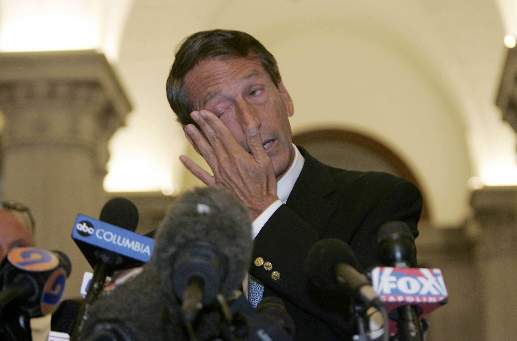 South Carolina Governor Mark Sanford wipes his eyes as he speaks to the media about his trip to Buenos Aires, Argentina and admits to an extramarital affair at the State House in Columbia, South Carolina, June 24, 2009. Governor Sanford said on Wednesday he was resigning as Chairman of the Republican Governors' Association after admitting to having an affair and being unfaithful to his wife. "I've been unfaithful to my wife," he told a news conference in the South Carolina capital of Columbia after returning from a secret private trip to Argentina.  REUTERS/Erik Campos/The State   (UNITED STATES POLITICS IMAGE OF THE DAY TOP PICTURE) (Reuters)