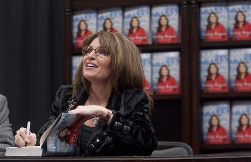 Former Alaska Gov. Sarah Palin signs a copy of "Going Rogue" during a book signing event at a Sam's Club on Thursday, Dec. 3, 2009, in Fayetteville, Ark. (AP Photo/Beth Hall) (AP)