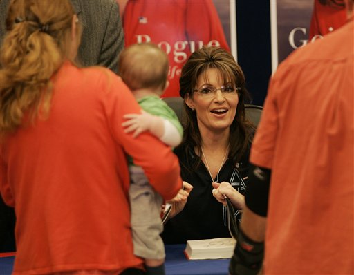 Former Alaska Gov. Sarah Palin signs a copy her her autobiography, "Going Rogue", at the North Post Exchange at Fort Bragg, N.C., Monday, Nov. 23, 2009. (AP Photo/Jim R. Bounds) (Associated Press)