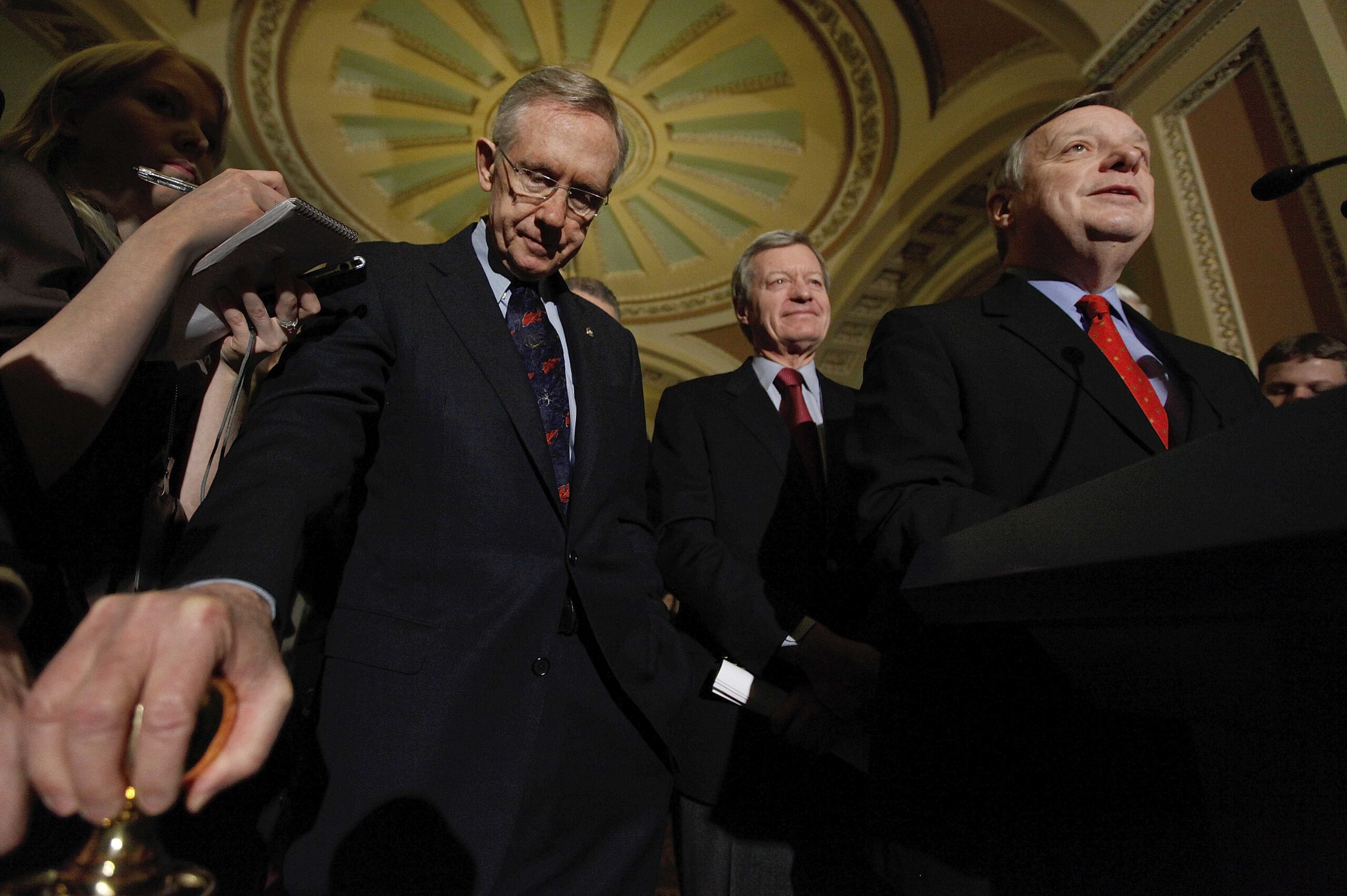 Senate Majority Leader Harry Reid of Nev., left, and Senate Finance Committee Chairman Sen. Max Baucus, D-Mont., center, listen as Senate Majority Whip Richard Durbin of Ill. speaks on Capitol Hill in Washington, Thursday, Dec. 24, 2009, after the Senate passed the health care reform bill. (AP Photo/Manuel Balce Ceneta) (Associated Press)