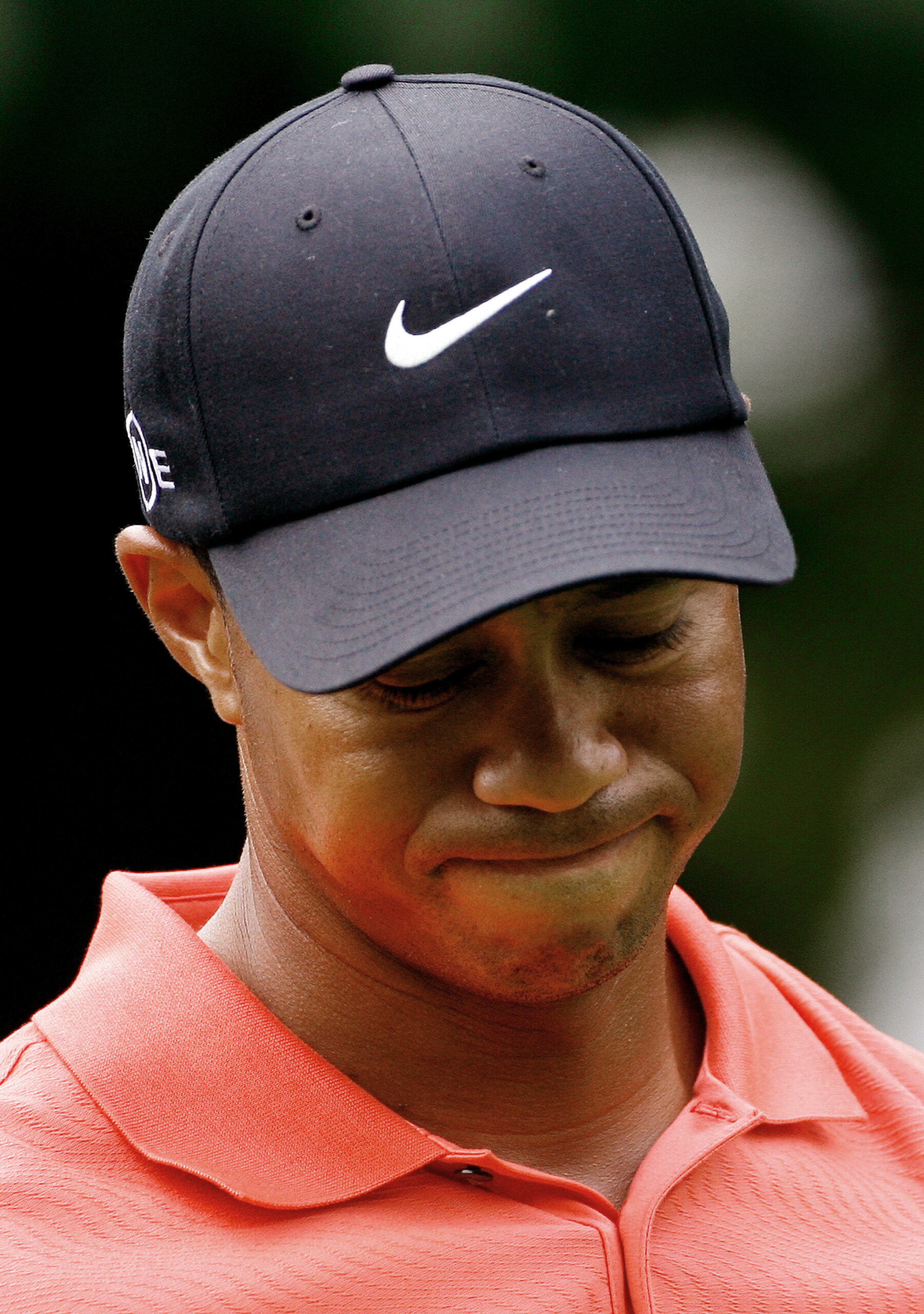U.S. golfer Tiger Woods reacts after teeing off at the 14th hole during the World Match Play Championship at the Wentworth Club in Virginia Water, southeast England, September 14, 2006. World number one Woods, who arrived at Wentworth on the back of a remarkable run of five successive tournament wins, wielded a cold putter all day as he lost 4 & 3 to fellow American Shaun Micheel. REUTERS/Kieran Doherty  (BRITAIN) (Reuters)