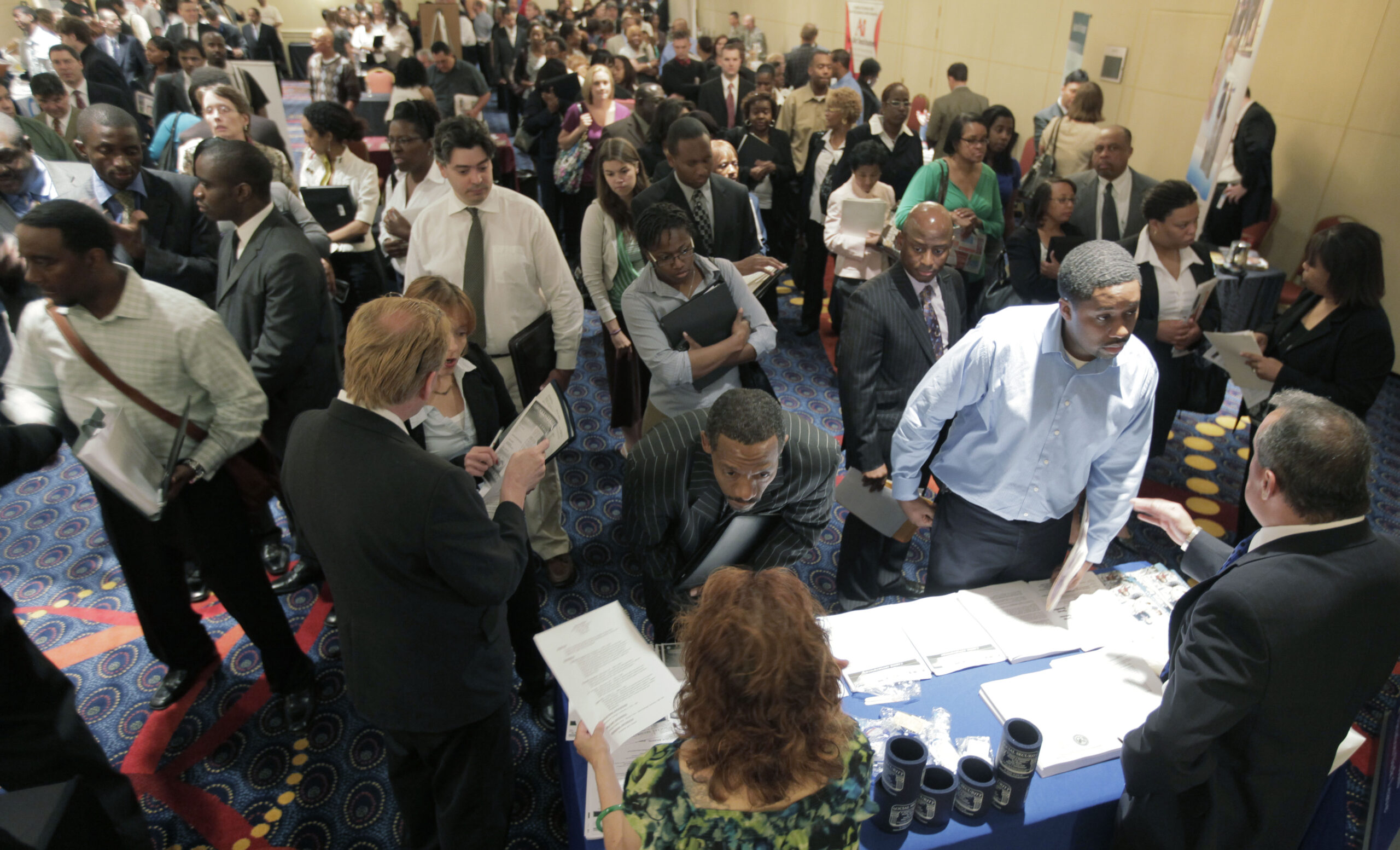 Brandon Dodd, right, listens to Rene Torres, a recruitment associate with the Social Security Administration at a  career fair, Thursday, July 2, 2009 in Oak Brook, IL Employers nationally cut a larger-than-expected 467,000 jobs in June and the unemployment rate climbed to a 26-year high of 9.5 percent. (AP Photo/M. Spencer Green) (M. Spencer Green)