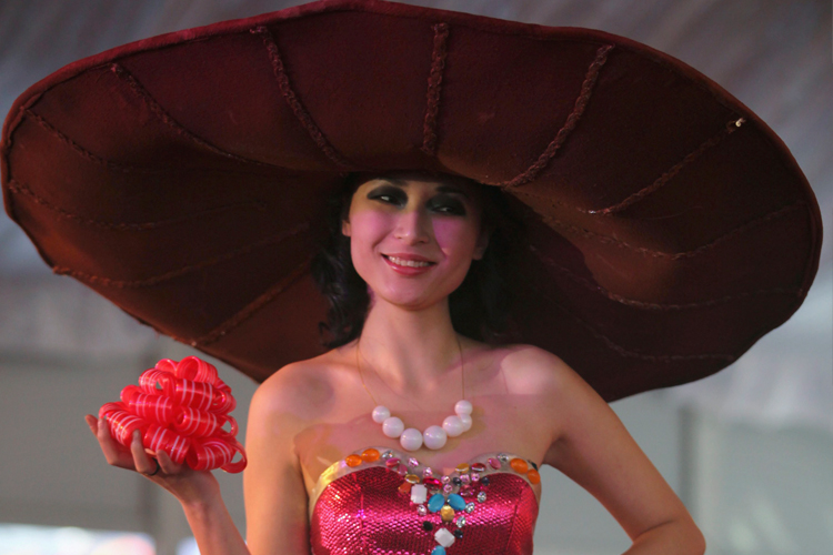A model wears a creation made of chocolate during a fashion show at the World Chocolate Wonderland, a chocolate theme park, in Beijing.