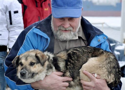 In this photo taken Tuesday, Jan. 26, 2010 and made available Thursday, Jan 28, 2010 Adam Buczynski carries a dog found floating cold and alone on an ice floe 15 miles off the Polish Baltic Sea coast in Gdynia,  Poland. Buczynski, a sailor from the ship "Baltic"  pulled out the dog from the ice floe. (AP Photo/Maciej Czoska)  ** POLAND OUT ** (AP)