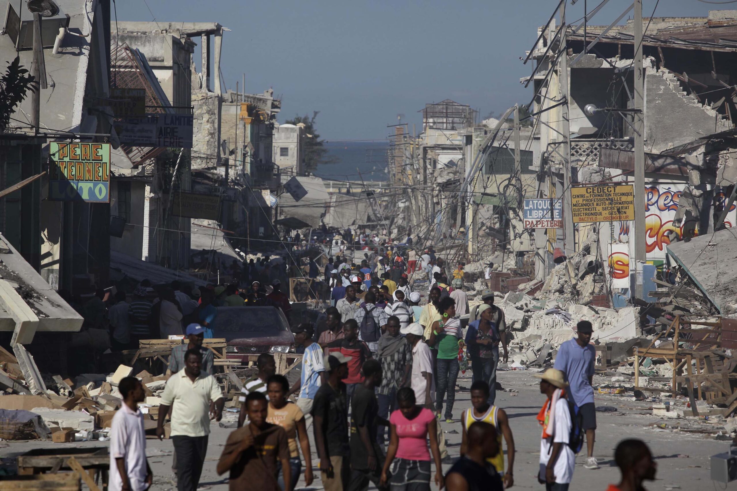 Displaced Haitians walk the streets amidst collapsed buildings and rubble in downtown Port Au Prince Thursday, Jan. 14, 2010, in Port au Prince, Haiti. (AP/Julie Jacobson)