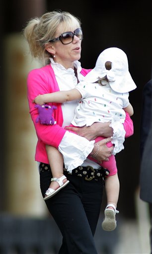 In this Aug. 6, 2009 file photo, Rielle Hunter leaves the Terry Sanford Federal Building and Courthouse in Raleigh, N.C. Former Democratic presidential candidate John Edwards has finally come forward to admit that he fathered the child with Hunter, a videographer he hired before his second White House bid. (AP Photo/Jim R. Bounds, File) (AP)