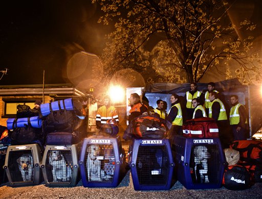 Rescue dogs are seen in their enclosure before leaving for Haiti at the Torrejon military airbase in Torrejon de Ardoz, Spain, Wednesday Jan. 13, 2010. Firefights without Borders, the International Red Cross and other aid groups said they are preparing a major disaster relief effort in Haiti after a powerful earthquake struck the capital. (AP Photo/Daniel Ochoa de Olza) (AP)