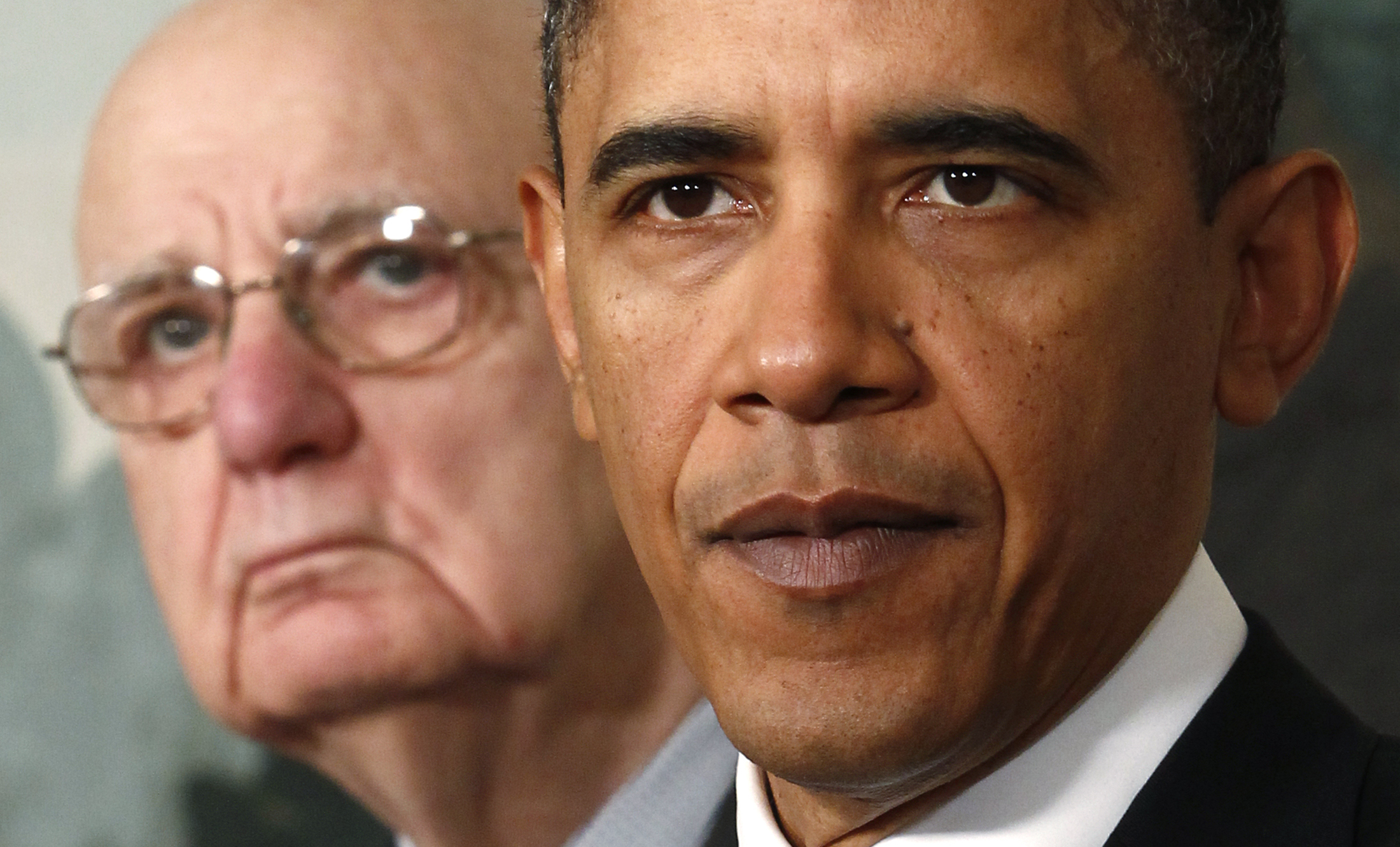 U.S. President Barack Obama speaks about financial reform after his meeting with Presidential Economic Recovery Advisory Board Chair Paul Volcker (L) at the White House in Washington January 21, 2010. Obama proposed stricter limits on financial risk-taking on Thursday in a new populist-tinged move that sent bank shares lower and aimed to shore up his own political base. REUTERS/Kevin Lamarque (UNITED STATES - Tags: BUSINESS POLITICS HEADSHOT) (Reuters)
