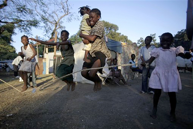 Girls play jump-rope at a makeshift camp in Port-au-Prince, Haiti, on Jan. 21.