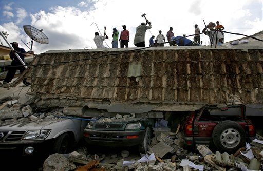 People search for survivors under the rubble of a collapse building the day after an earthquake hit Port-au-Prince, Haiti, Wednesday, Jan. 13, 2010.  The 7.0-magnitude earthquake that hit Haiti on Tuesday flattened the president's palace, the cathedral, hospitals, schools, the main prison and whole neighborhoods. (AP Photo/Ricardo Arduengo) (AP)