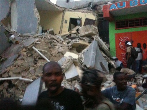**RETRANSMISSION FOR IMPROVED QUALITY** This photo provided by Carel Pedre shows people running past rubble of a damaged building in Port-au-Prince, Haiti, Tuesday, Jan. 12, 2010. The largest earthquake ever recorded in the area shook Haiti on Tuesday, collapsing a hospital where people screamed for help. (AP Photo/Carel Pedre) MANDATORY CREDIT: CAREL PEDRE; NO SALES (AP)