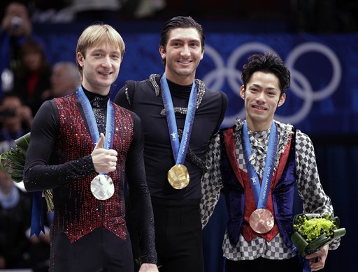 Gold medallist Evan Lysacek of the USA, center, silver medallist Evgeni Plushenko of Russia, left, and bronze medallist Daisuke Takahashi of Japan, right, pose on the podium during the medal ceremony for the men's figure skating competition at the Vancouver 2010 Olympics in Vancouver, British Columbia, Thursday, Feb. 18, 2010. (AP Photo/David J. Phillip) (AP)