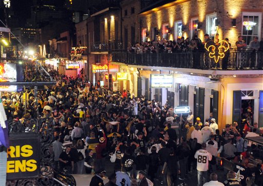 FILE - In tis Jan. 24, 2010, file photo, New Orleans Saints fans flock to Bourbon Street in New Orleans, after the Saints defeated the Minnesota Vikings 31-28 in the NFC championship NFL football game. This weekend is the first big weekend of Mardi Gras as well as the Saints playing in the Super Bowl on Sunday, Feb. 7, in Miami. There are four parades scheduled in New Orleans on Saturday and two on Sunday _ both of which are rolling early to avoid conflicting with the game.  (AP Photo/Cheryl Gerber, File) (AP)