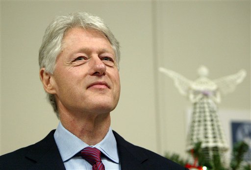 FILE - In this Dec. 23, 2004 file photo Former President Bill Clinton waits his turn at the podium before formally thanking the staff at Westchester Medical Center, in Valhalla, N.Y. for diagnosing the heart condition that led to his quadruple bypass surgery in August. Clinton was hospitalized with chest pain at a New York hospital, Thursday, Feb. 11, 2010. (AP Photo/Kathy Willens, File) (AP)