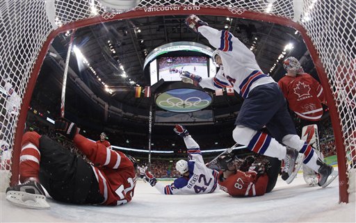 USA's Bobby Ryan celebrates a goal against Canada by teammate Chris Drury, not shown, in the second period of a preliminary round men's ice hockey game at the Vancouver 2010 Olympics in Vancouver, British Columbia, Sunday, Feb. 21, 2010. Canada's Dan Boyle (22), left, Sidney Crosby (87), center, and  goalie Martin Brodeur (30) were in on the play. (AP Photo/Julie Jacobson) (AP)