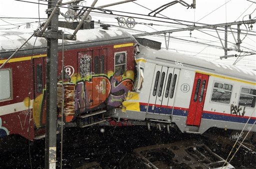 The wreckage of two commuter trains is seen in Buizingen, Belgium Monday, Feb. 15, 2010. Two commuter trains collided head-on at rush hour in a Brussels suburb Monday, killing 20 people, Belgian officials said. (AP Photo/Yves Logghe) (AP)