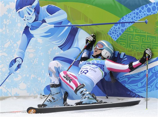 Julia Mancuso of the United States falls back on to the finish area fencing after finishing the second run of the Women's giant slalom, at the Vancouver 2010 Olympics in Whistler, British Columbia, Thursday, Feb. 25, 2010. (AP Photo/Gero Breloer) (AP)