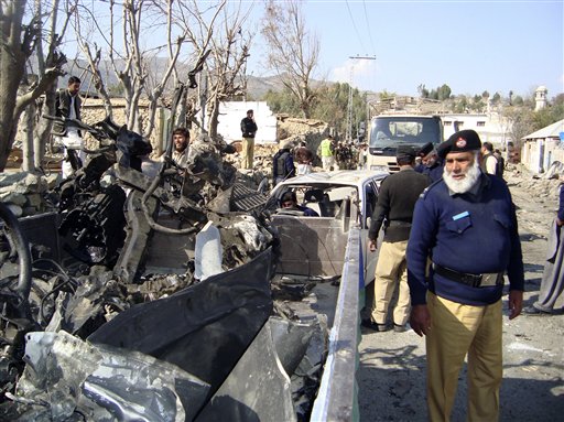 A Pakistani police officer looks at remains of a vehicle destroyed by a bomb explosion in Lower Dir, Pakistan on Wednesday, Feb. 3, 2010. Three U.S. soldiers traveling with Pakistan security force members were killed Wednesday in a roadside bombing near a girl's school in northwest Pakistan, Pakistani security officials said. Other casualties included school children. (AP Photo/ Naveed Ali) (AP)