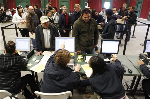 In this Sunday, Jan. 23, 2010 photo, Job applicants, upper, talk with job recruiters at a job fair in Santa Clara, Calif. The number of new claims for unemployment benefits fell less than expected last week, fresh evidence the job market remains a weak spot in the economic recovery.(AP Photo/Paul Sakuma) (AP)