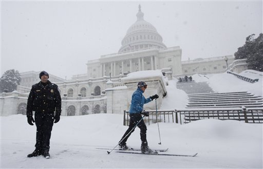 Emily Tibbott skis past U.S. Capitol Police Officer Sean Whitehead, standing guard on Capitol Hill in Washington, Wednesday, Feb. 10, 2010, as more snow fell in the Washington area.  (AP Photo/Manuel Balce Ceneta) (AP)