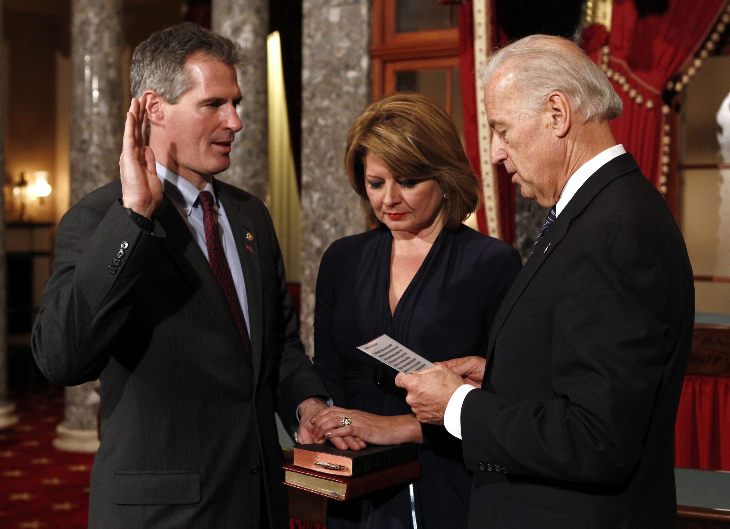 Republican Massachusetts Senator Scott Brown (L) is ceremonially sworn into office by U.S. Vice President Joe Biden (R) in the U.S. Capitol in Washington February 4, 2010. Holding the Bible is Brown's wife Gail Huff.  REUTERS/Kevin Lamarque   (UNITED STATES - Tags: POLITICS) (Reuters)