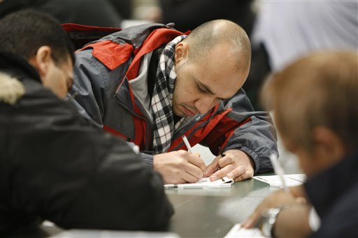 In this photo made Sunday, Jan. 23, 2010, job applicants fill out forms at a job fair in Santa Clara, Calif. The number of new claims for unemployment benefits fell less than expected last week, fresh evidence the job market remains a weak spot in the economic recovery.(AP Photo/Paul Sakuma) (AP)