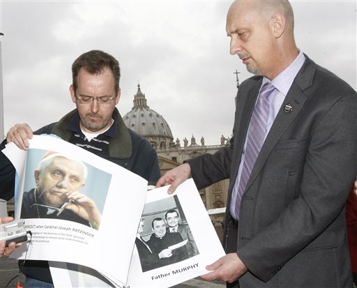 **  CORRECTS DATE  **  John Pilmaier from Milwaukee, left, and Peter Isely of the SNAP bureau (Survivors Network of those Abused by Priests) show pictures of Cardinal Joseph Ratzinger  now Pope Benedict XVI, left,  and of father Lawrence Murphy,  as they stage a press conference in front of The Vatican Thursday, March 25, 2010. SNAP members denounce Benedict's handling of the case that involved father Murphy, who died in 1998, accused of molesting some 200 deaf boys as he worked at the former St. John's School for the Deaf in St. Francis from 1950 to 1975. Cardinal Joseph Ratzinger's deputy at the Congregation for the Doctrine of the Faith,ruled that the alleged molestation had occurred too long ago and that the accused priest, Rev. Lawrence Murphy, should instead repent and be restricted from celebrating Mass outside of his home diocese. (AP Photo/Pier Paolo  Cito) (AP)