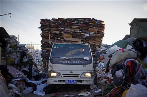 A Chinese driver with a truck full of cardboard set for recycling arrives at a recycling center in Beijing, China, Tuesday, Dec. 15, 2009. China, India and other developing nations boycotted U.N. climate talks Monday, bringing negotiations to a halt with their demand that rich countries discuss much deeper cuts in their greenhouse gas emissions. (AP Photo/Elizabeth Dalziel) (AP)