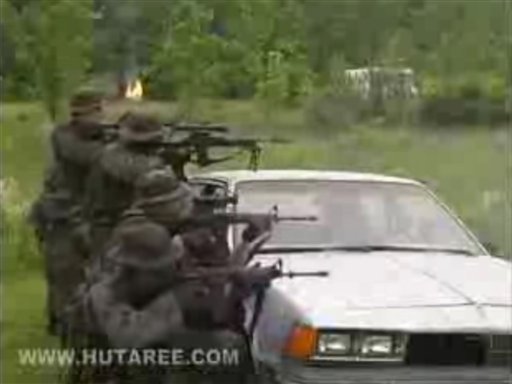 This screen grab made Monday March 29, 2010 from the Christian militia group Hutaree's site allegedly shows training videos. Nine suspects tied to a Christian militia that was preparing for the Antichrist were charged with conspiring to kill police officers, then kill scores more by attacking a funeral using homemade bombs, federal prosecutors said Monday. The Michigan-based group, called Hutaree, planned to use the attack on police as a catalyst for a larger uprising against the government, according to newly unsealed court papers.  (AP Photo/Hutaree.com) NO SALES (AP)