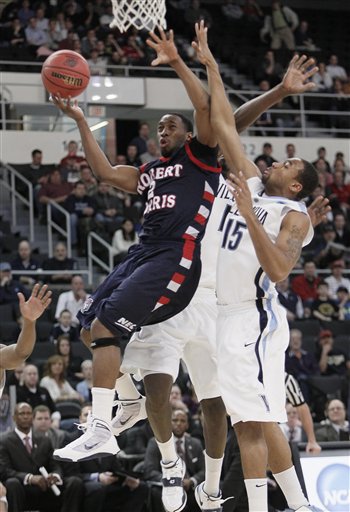 Robert Morris' Mezie Nwigwe (2) drives past Villanova's Reggie Redding (15) during the first half of an NCAA first-round college basketball game in Providence, R.I., Thursday, March 18, 2010. (AP Photo/Winslow Townson) (AP)